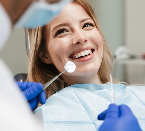 Woman at dental checkup smiling at her Windham dentist