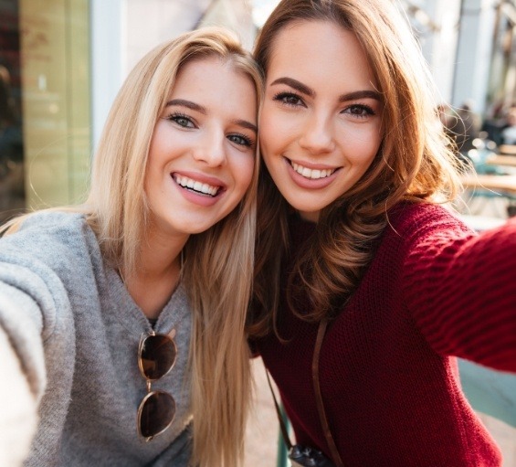 Two young women taking selfie after cosmetic dentistry in Windham