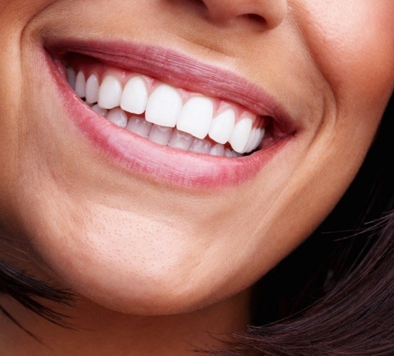 Close up of person with straight white teeth smiling