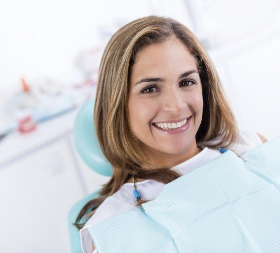 Smiling woman in dental chair visiting emergency dentist in Windham
