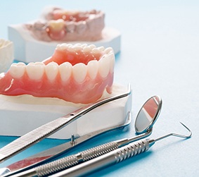 full dentures sitting on a plaster mold of a mouth