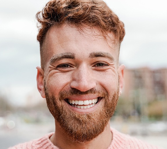 man standing outside smiling