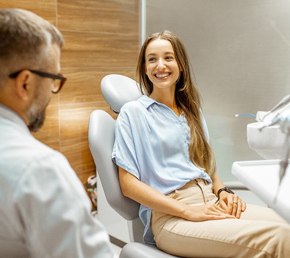 Dentist showing patient model of teeth