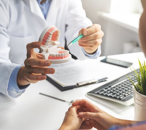 Female patient smiling at dentist at dental appointment